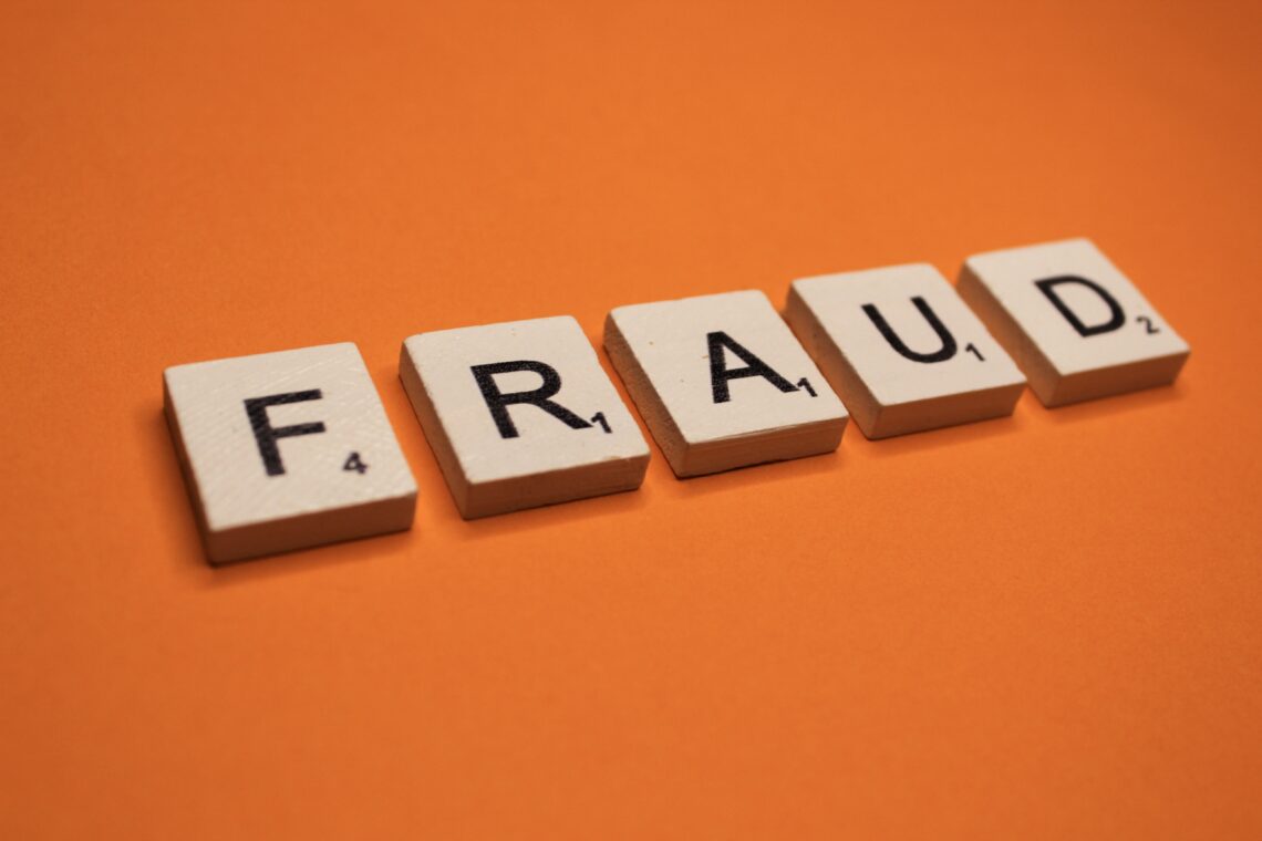 fraud-scrabble-letters-word-on-a-orange-background-2023-11-27-05-05-48-utc