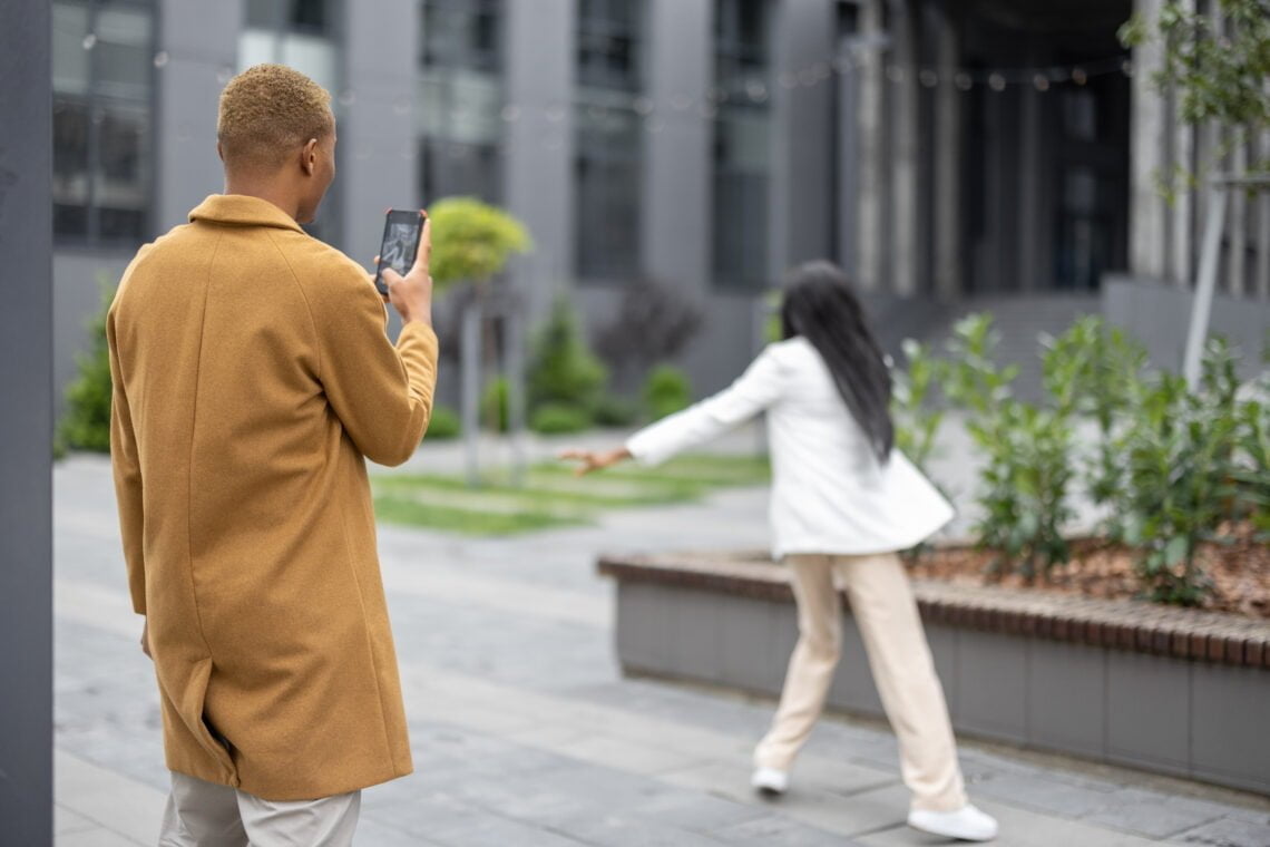 man taking photo on smartphone of his girlfriend 2023 11 27 05 17 39 utc