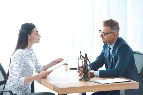 side view of lawyer and client discussing papers i 2023 11 27 05 33 26 utc