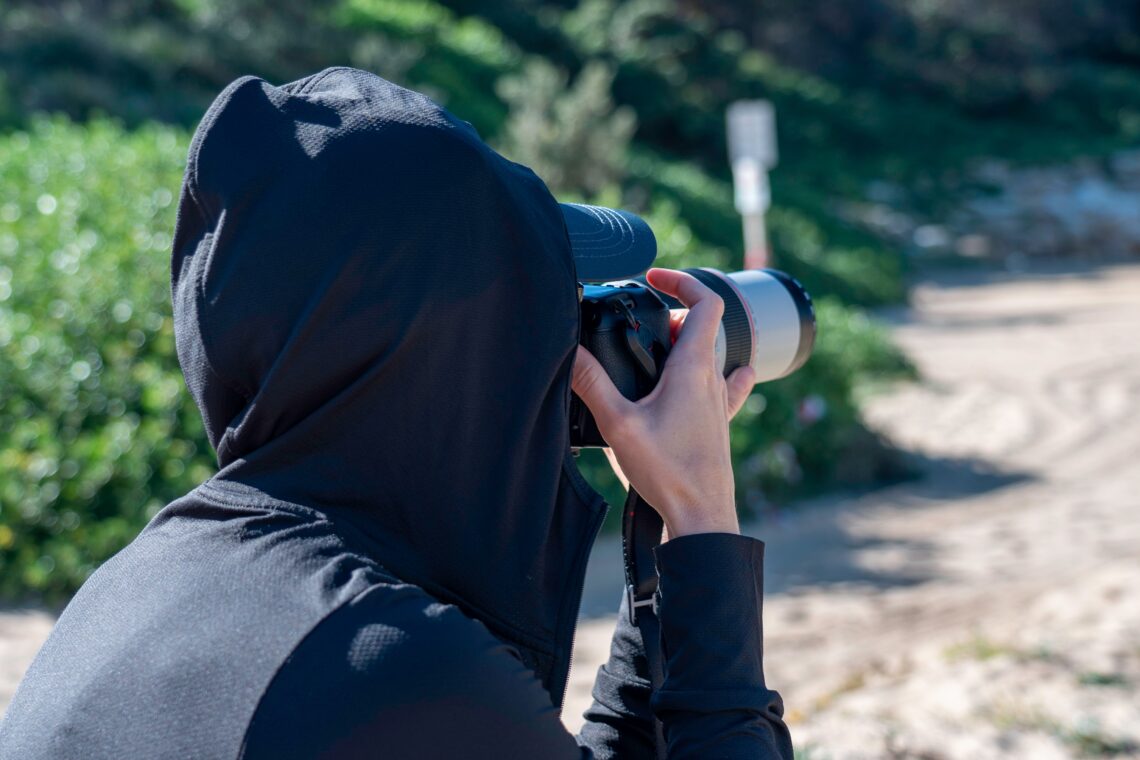women photographer taking a photo at the beach dur 2023 11 27 05 12 21 utc